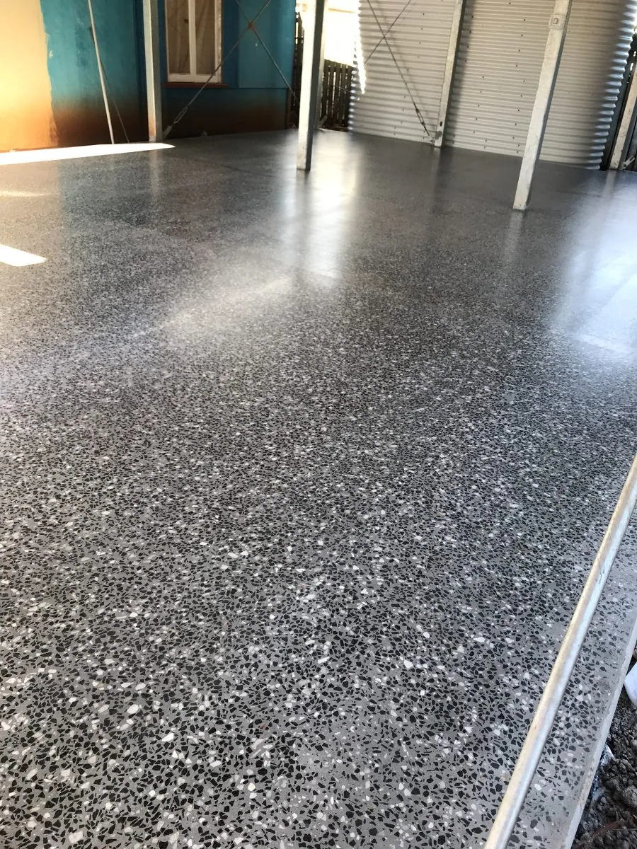 Charcoal hybrid concrete floor with exposed white and black aggregate in a Brisbane renovation by OzGrind