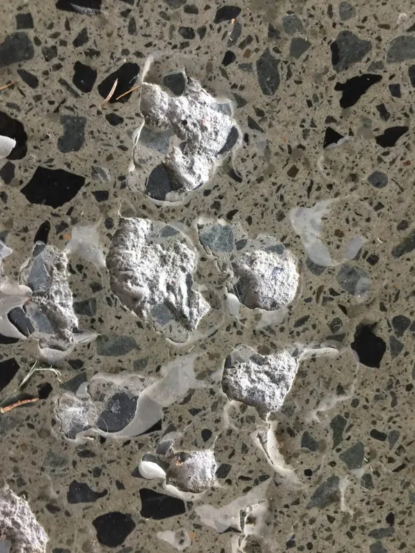 Epoxy coating delaminating from moisture on an outdoor concrete floor