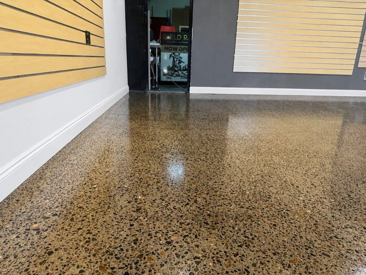 Honed polished concrete floor with exposed aggregate in a Brisbane retail showroom by OzGrind