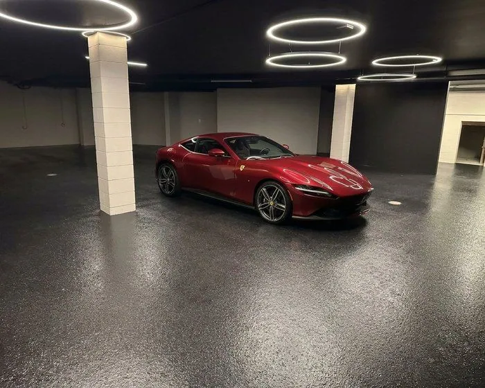 Epoxy flake garage floor Brisbane Red sports car parked on a flake epoxy garage floor in a Brisbane showroom