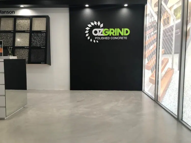 OzGrind polished concrete and micro cement showroom in Brisbane with finish samples and a seamless micro cement floor