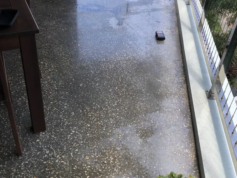 Moisture trapped under a grind and seal coating on an outdoor balcony floor
