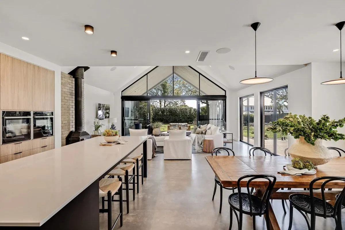 Open-plan polished concrete living and dining floor in a Brisbane home