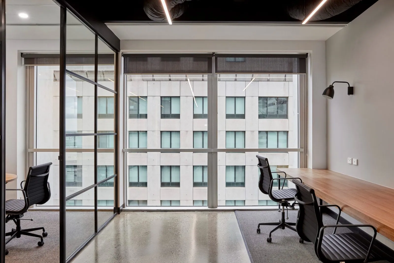Grind and seal polished concrete floor in a private office with desk and city outlook at the Archway commercial office fit-out, Brisbane