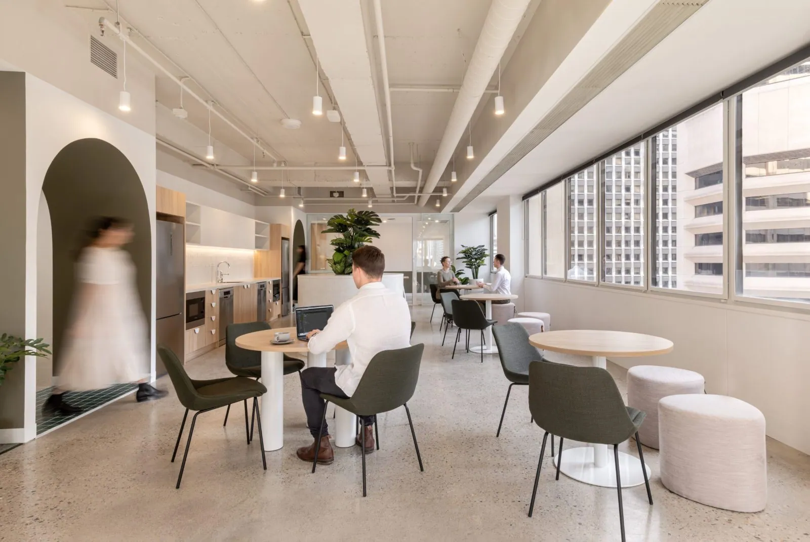 Grind and seal polished concrete floor in an office breakout area with booth seating at the Archway commercial office fit-out, Brisbane
