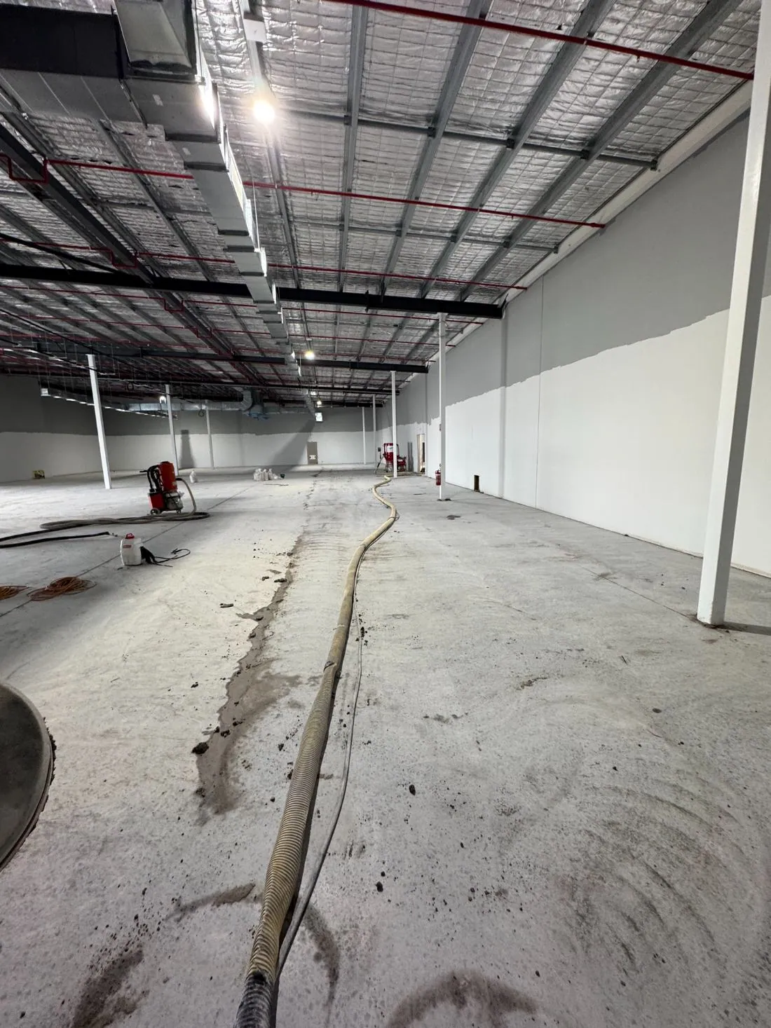 Dustless concrete grinding in progress with vacuum extraction