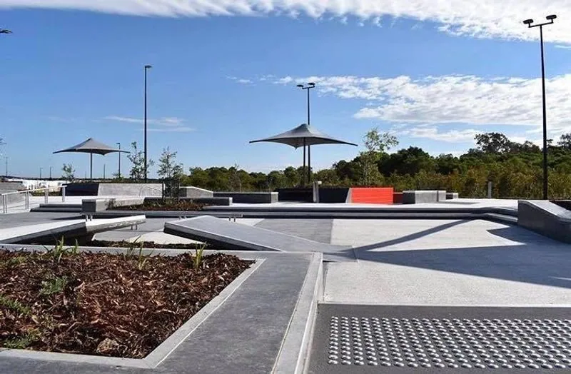 Outdoor honed concrete path and pergola through the Stockland Aura public parkland, Baringa