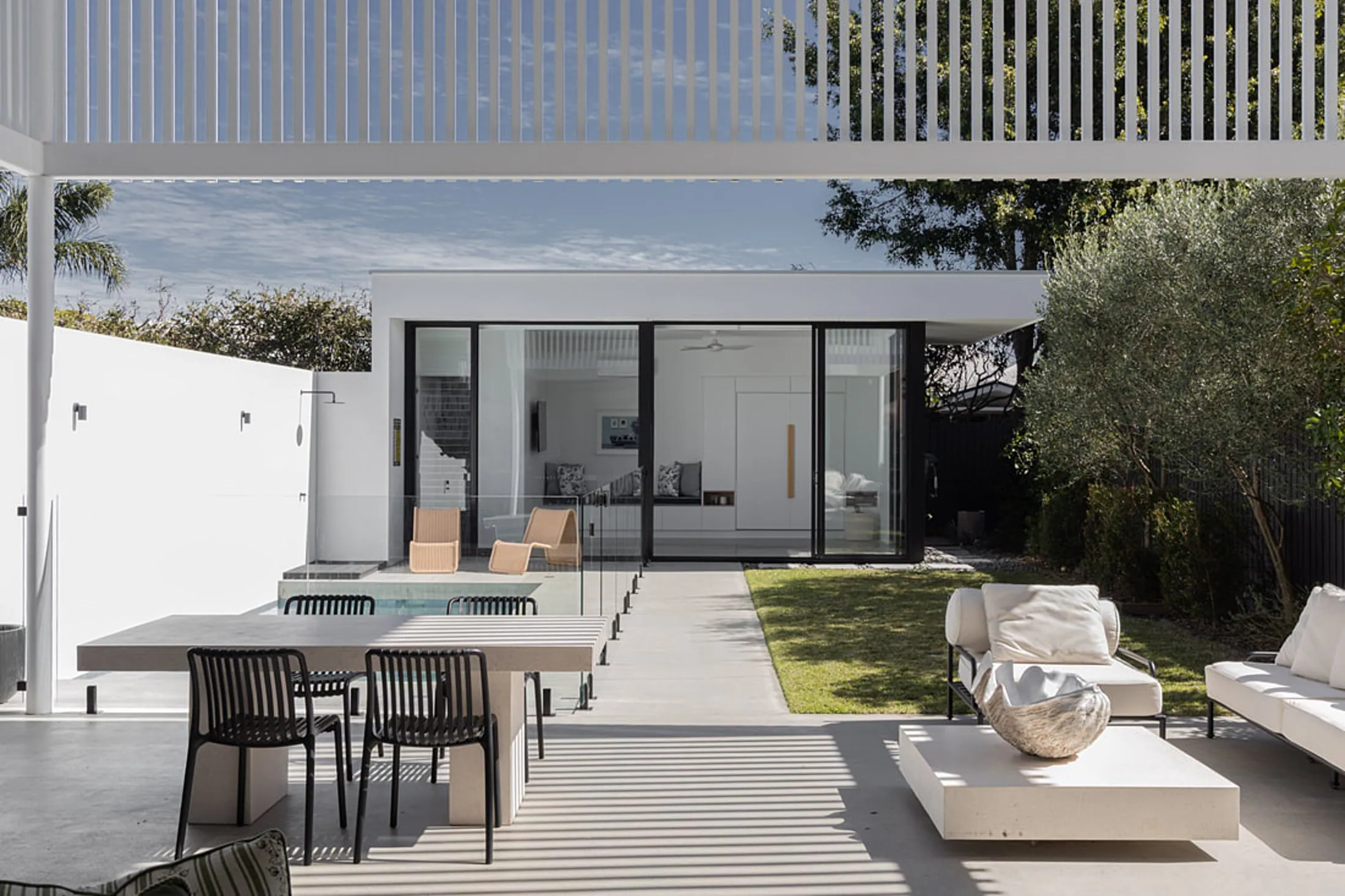 Honed concrete pool surrounds and outdoor entertaining area at a Brisbane home