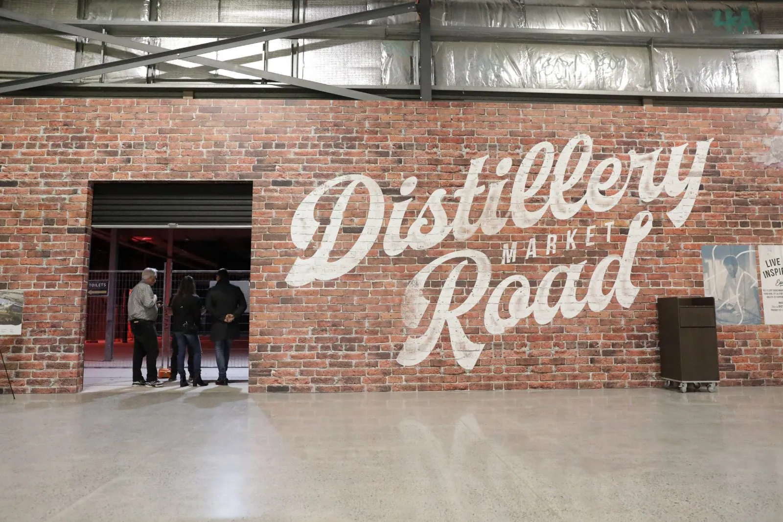 Polished concrete floor by the Distillery Road Market brick wall at the Zarraffas Coffee head office, OzGrind Brisbane