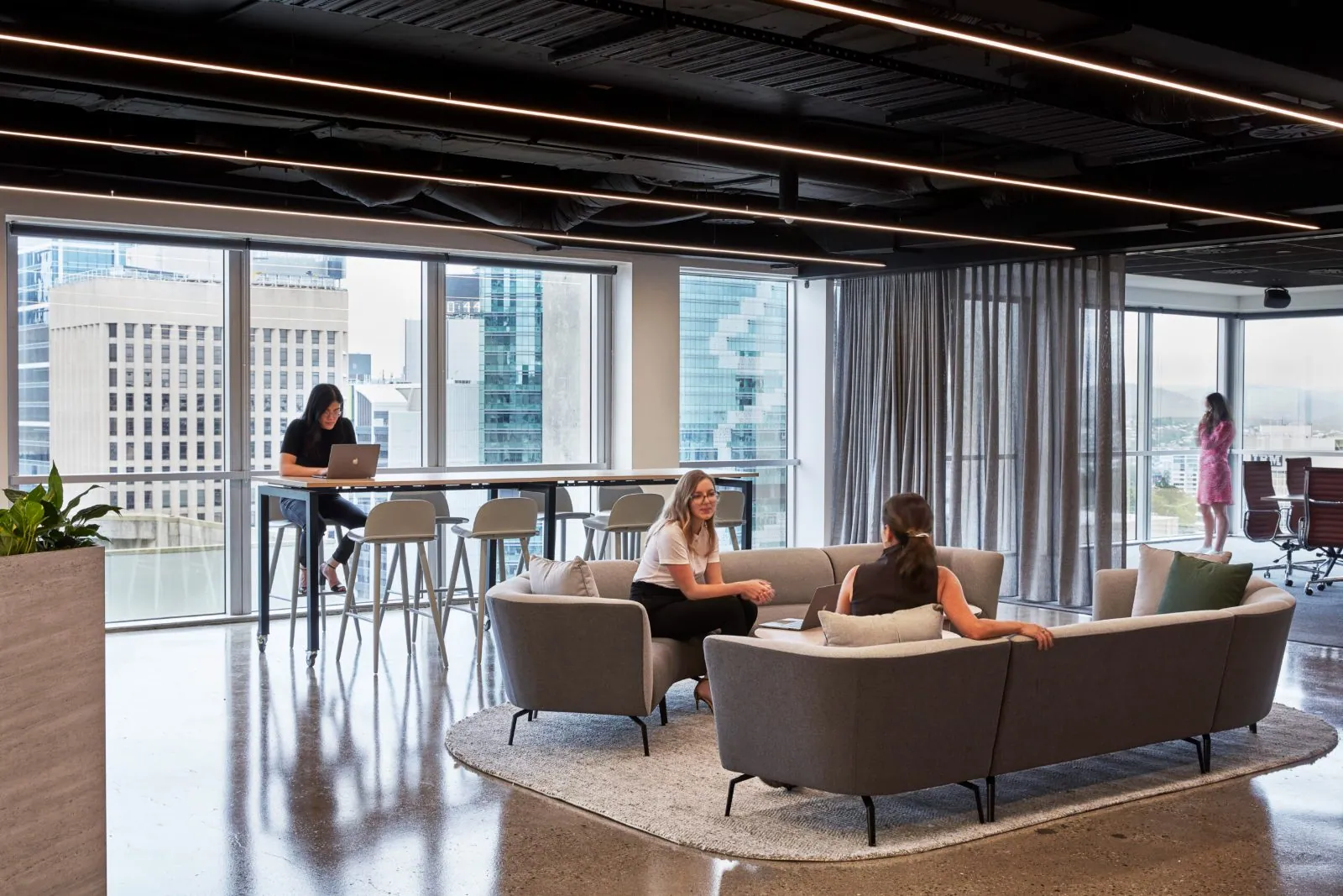 Grind and seal polished concrete floor in an office kitchen breakout beside an arched entry at the Archway commercial office fit-out, Brisbane