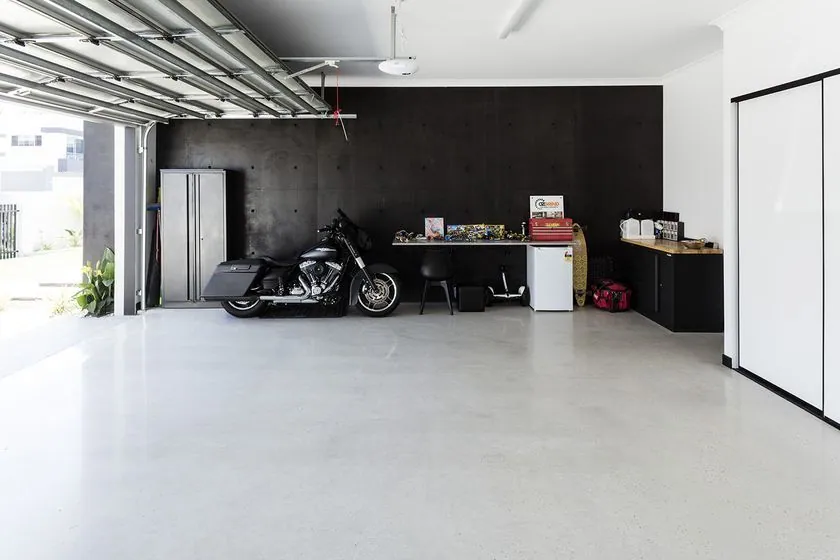 Polished concrete garage floor Brisbane Polished concrete garage floor in a Brisbane home with a motorcycle and OzGrind storage