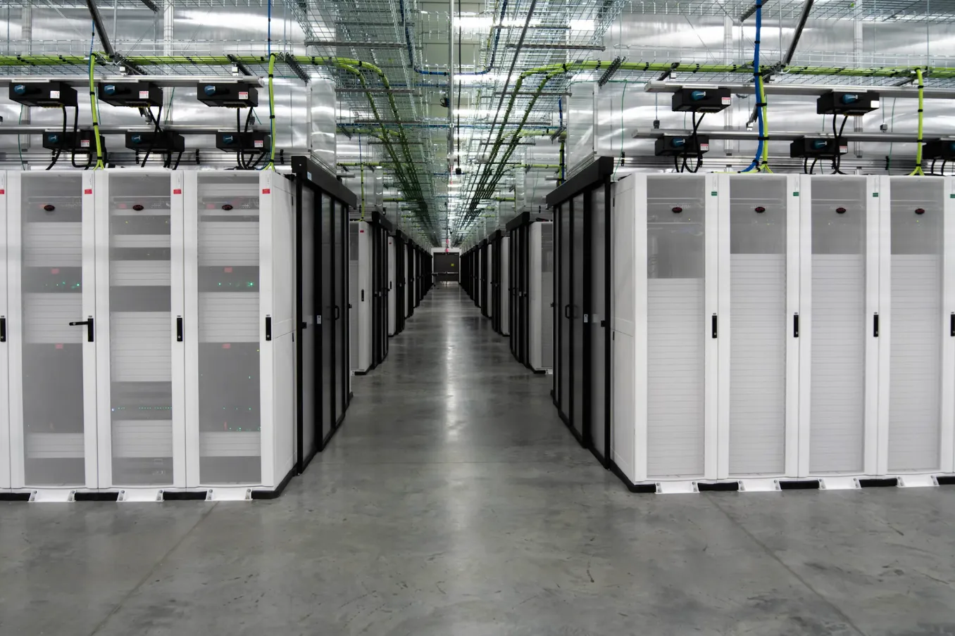 Polished concrete floor between white server cabinets in a data centre