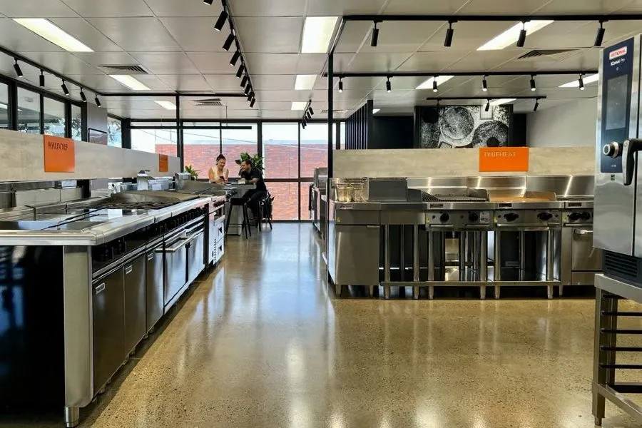 High-gloss grind and seal concrete floor in a Brisbane commercial kitchen showroom
