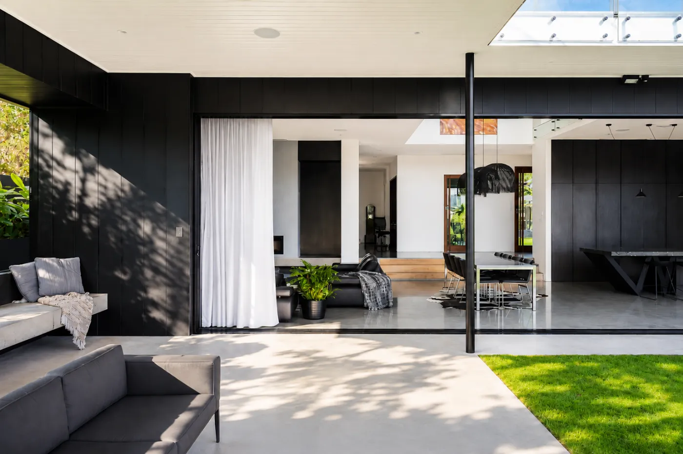 Grey honed concrete indoor-outdoor living and patio floor in a Brisbane home