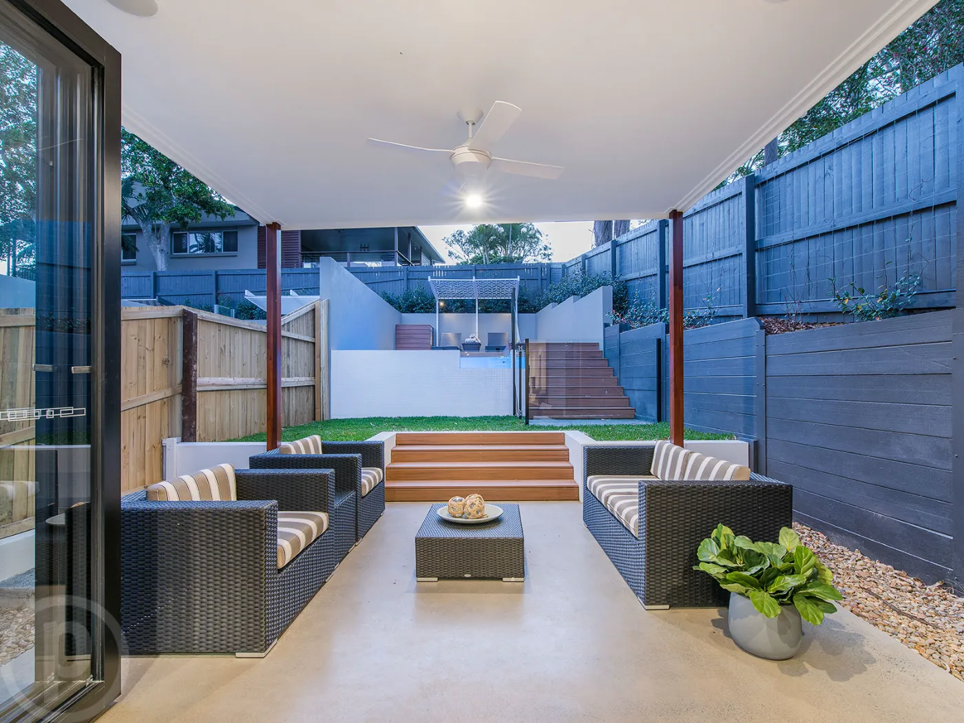 Nil exposure honed concrete outdoor patio floor at a Brisbane house with pool