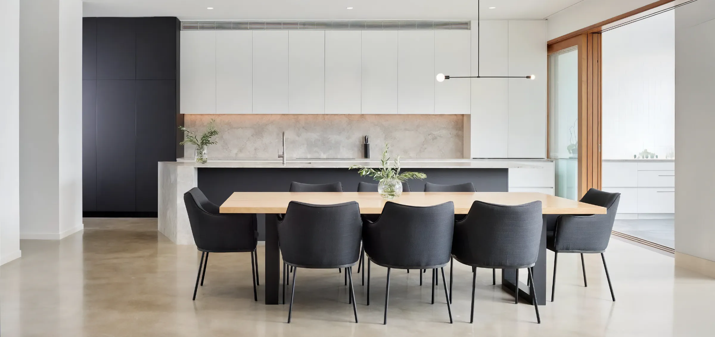Open plan living room with indoor polished concrete floors in a modern Brisbane home