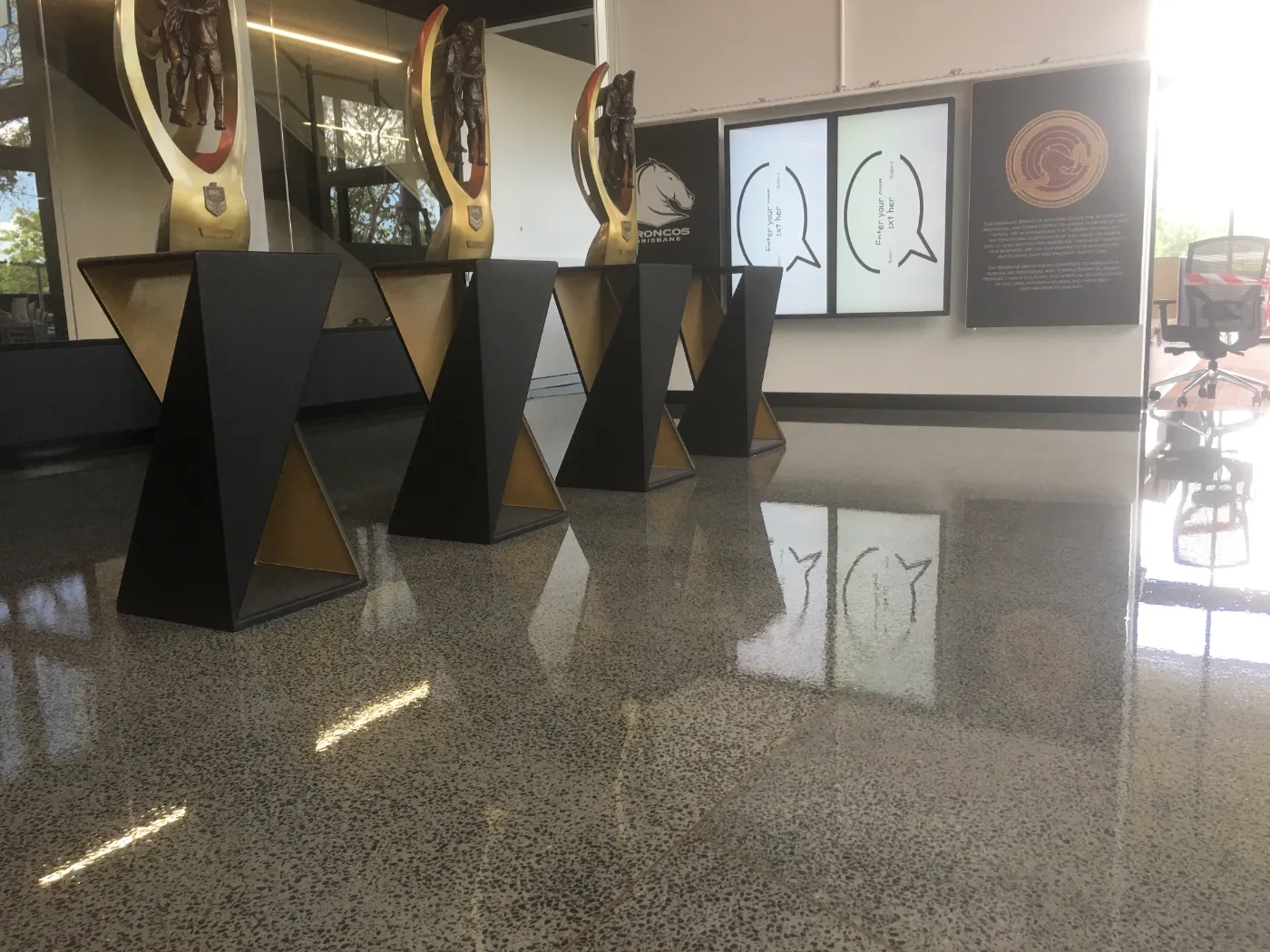 Grind and seal concrete floor with full stone exposure and a high gloss finish in the Brisbane Broncos trophy hall