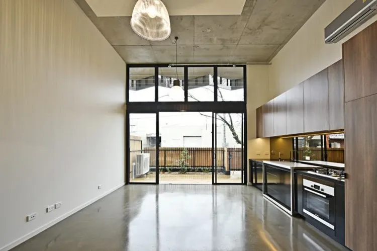 Grind and seal concrete floor with a nil stone exposure high gloss finish in a Brisbane apartment kitchen