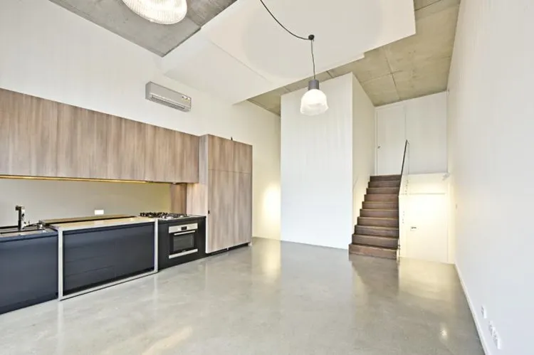 Grind and seal concrete floor with a nil stone exposure matte finish in a Brisbane apartment kitchen