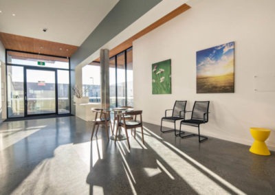 Spacious Lobby Area With Large Windows And A Mechanically Polished Concrete Floor.